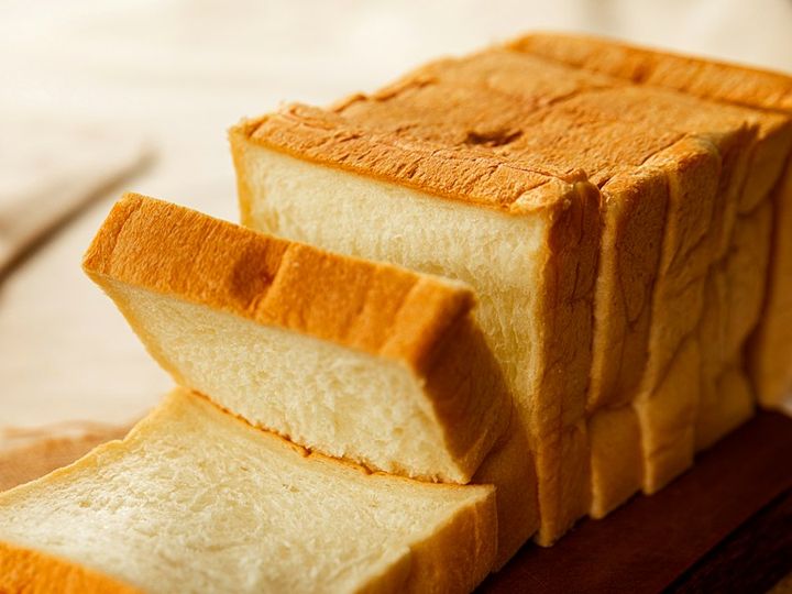 Sliced milk brioche loaf with a soft, pale crumb and golden crust