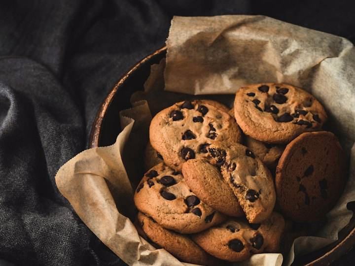 Chocolate chip cookies piled in a paper-lined bowl