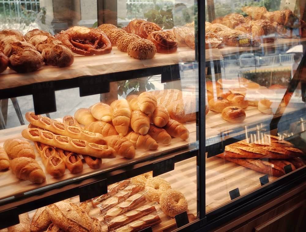 Bakery display counter stacked with fresh breads, baguettes and pastries