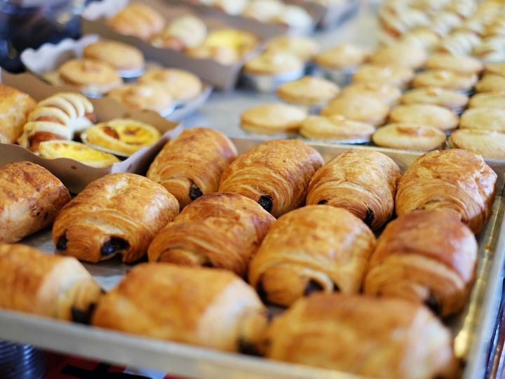 Trays of freshly baked pain au chocolat on the bakery counter