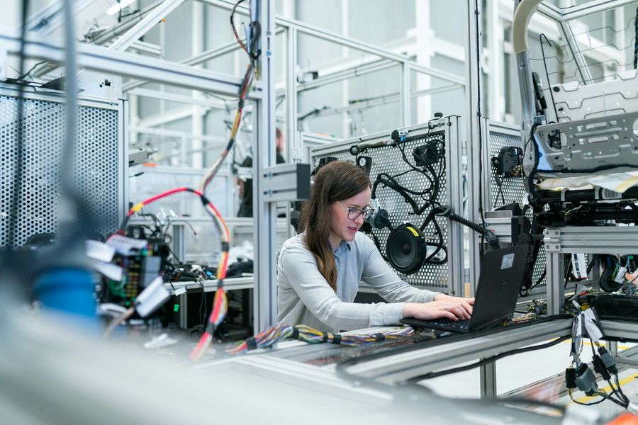 A student working at a laptop in the robotics and AI lab