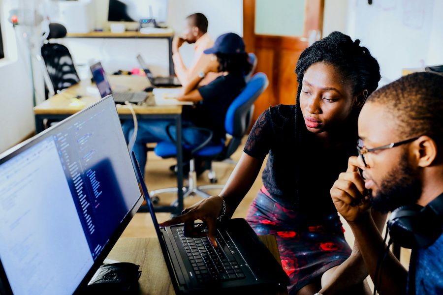 Two students reviewing code together in the data lab