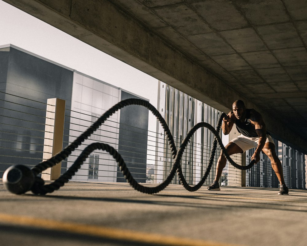 An athlete training with battle ropes