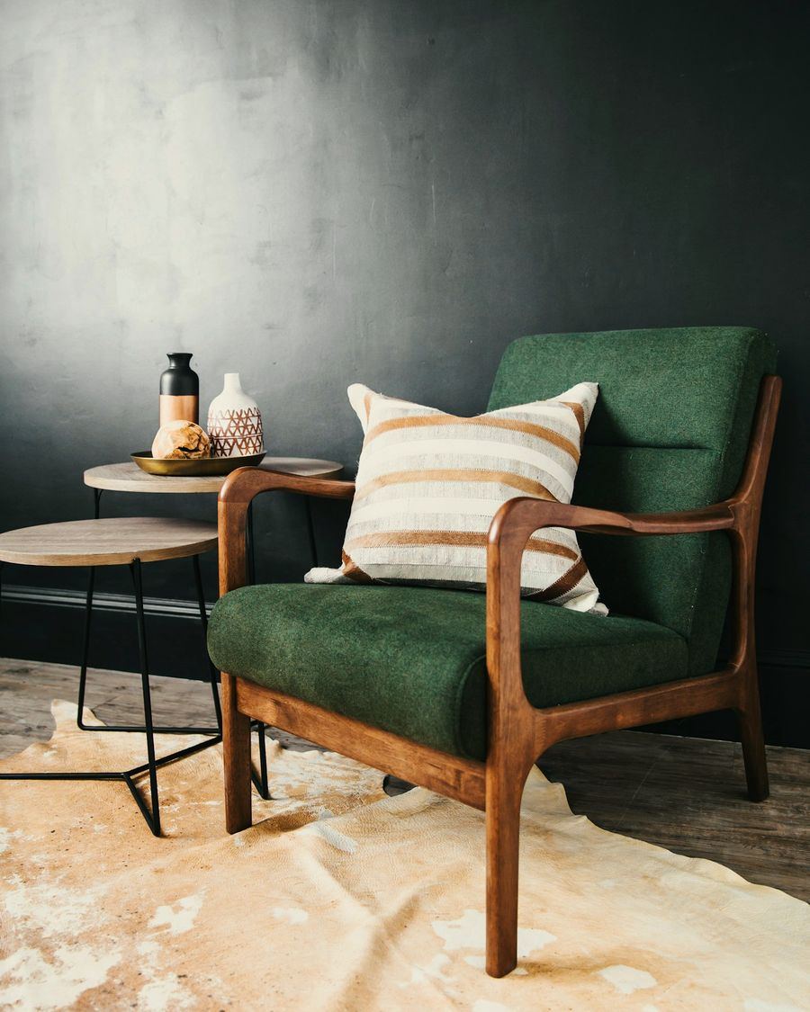 A walnut-framed armchair upholstered in bottle-green wool