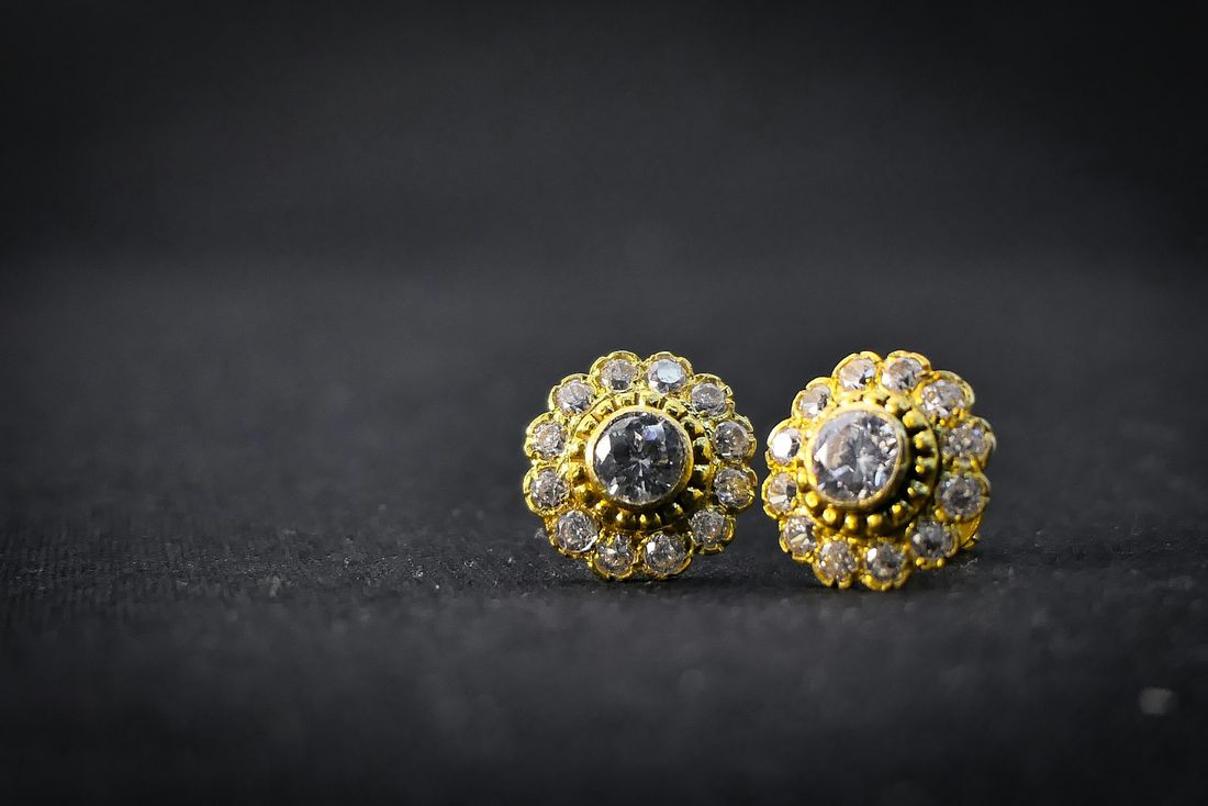 Diamond cluster ear studs on dark slate