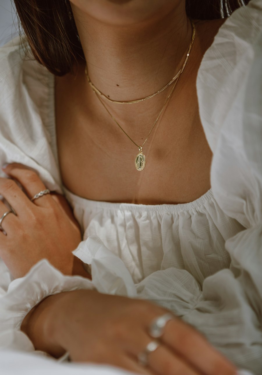 A fine chain worn over white linen