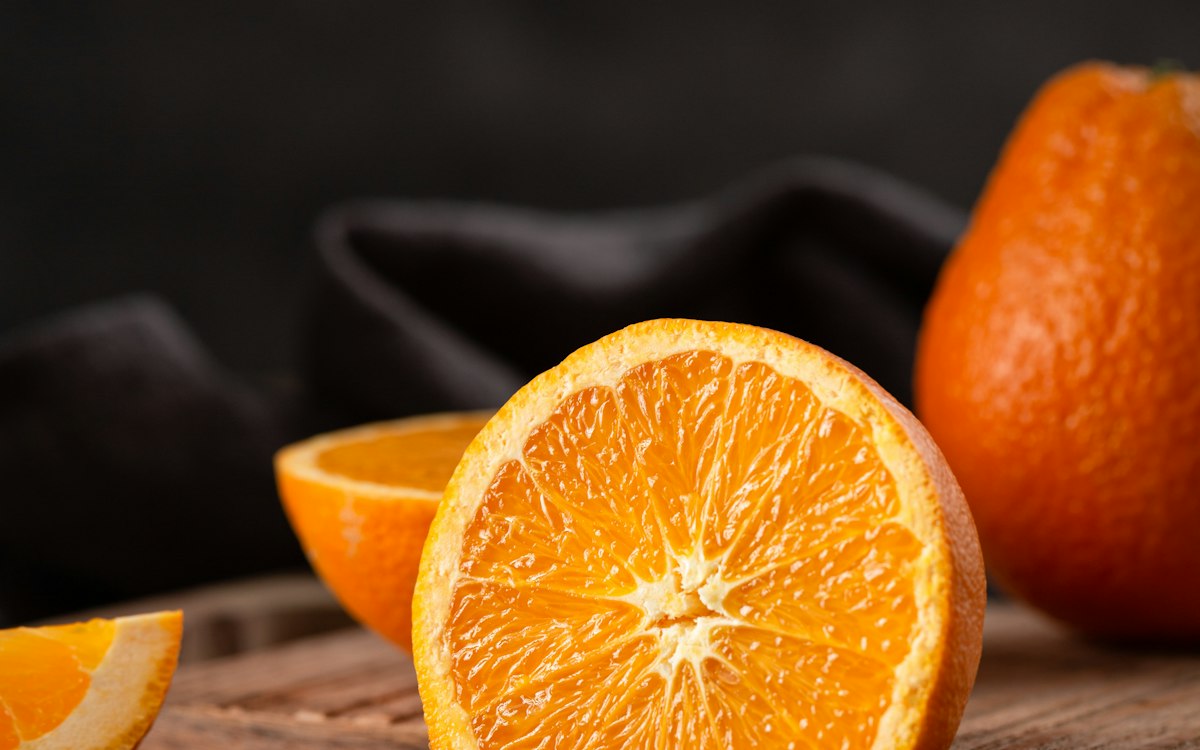 Halved citrus on a dark wooden board